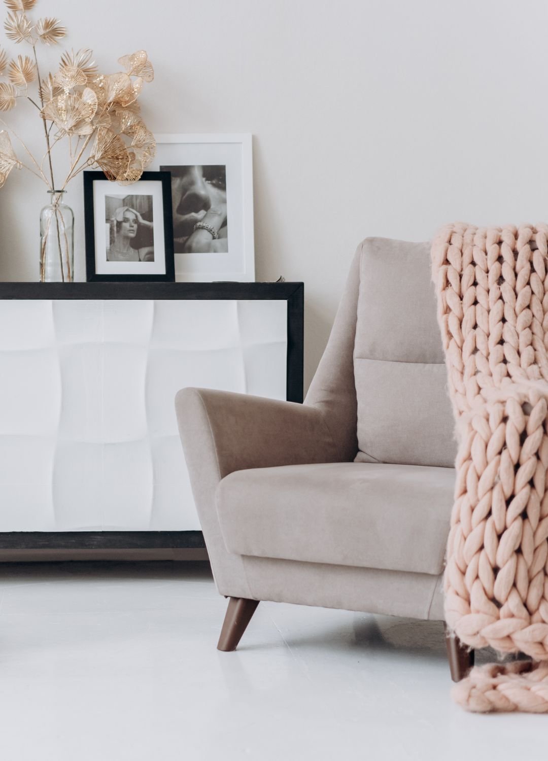 A living room with a chair and a blanket.