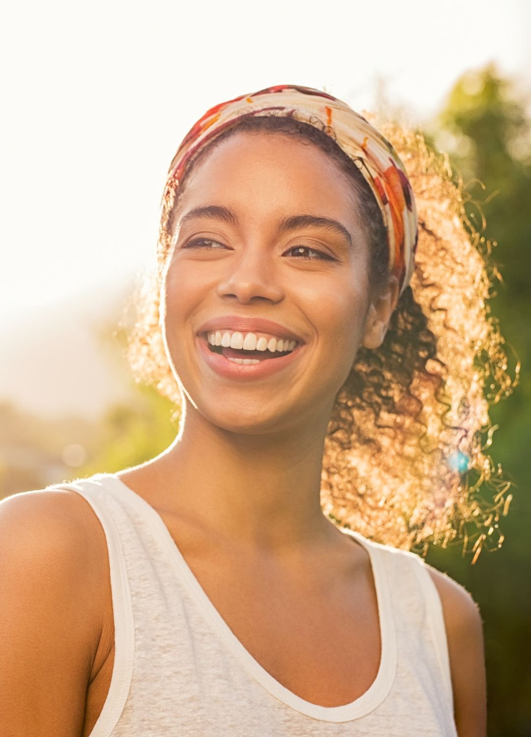 A young woman smiling in the sun.